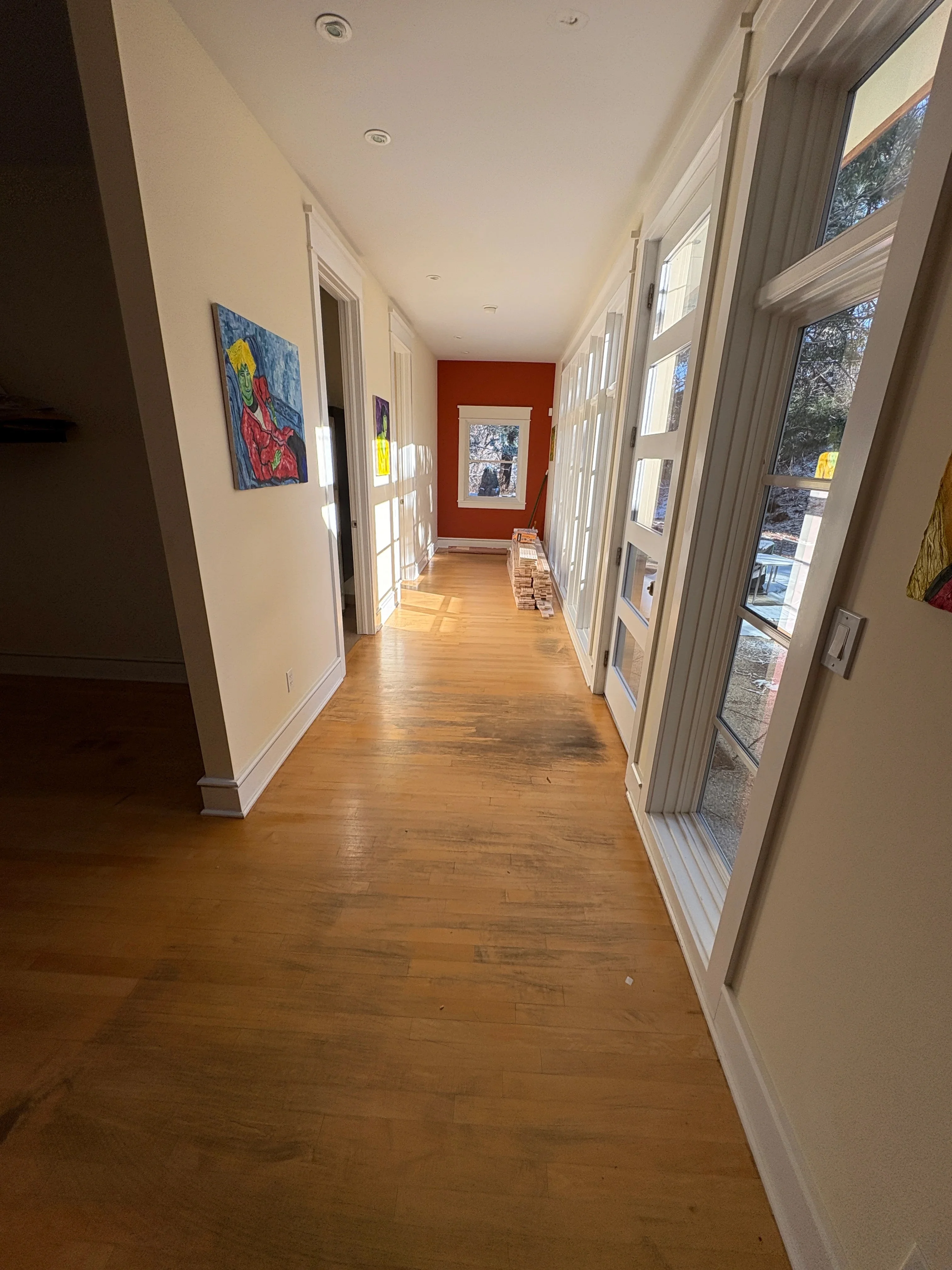 Hardwood flooring hallway with white trim, recessed lighting, and glass doors